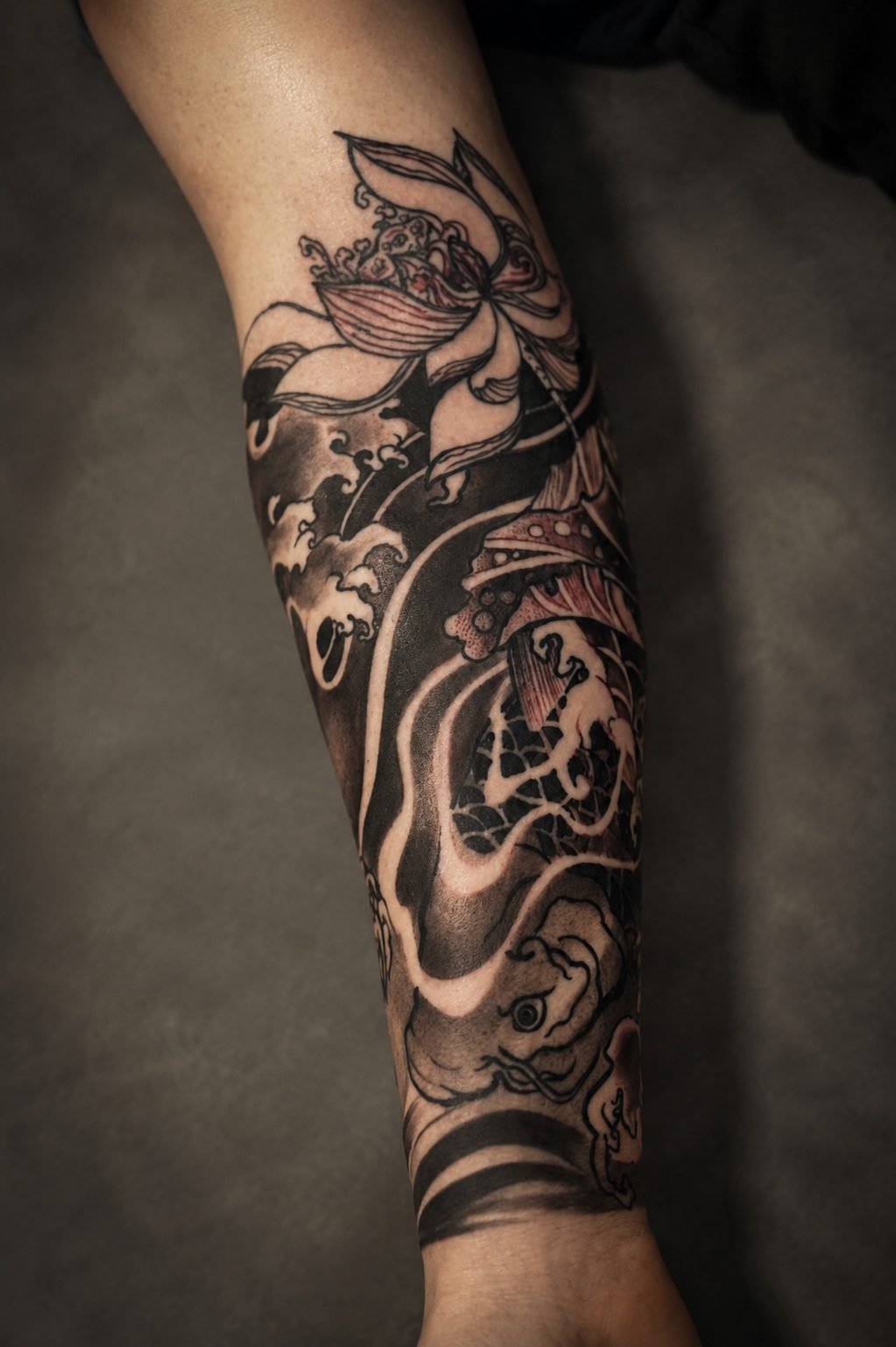Japanese koi and lotus leg piece by Erkan Zarif at THRONE Northampton