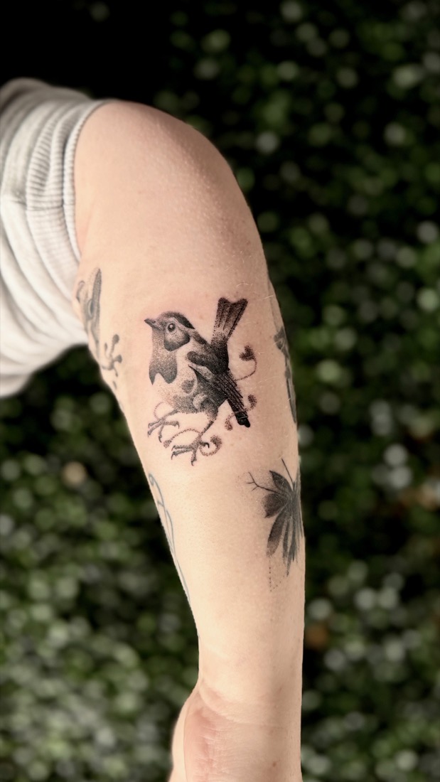 Dotwork bird perched on a branch, on an upper arm, by Tuba at THRONE Northampton