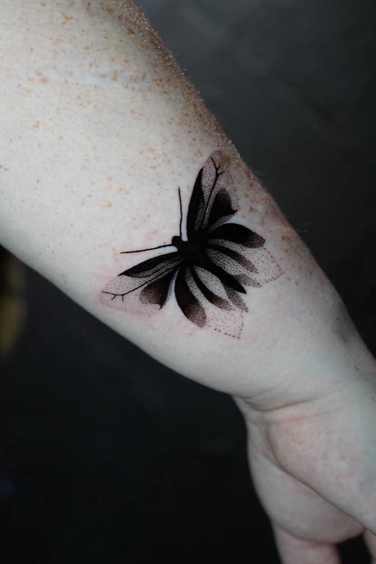 Dotwork butterfly on a forearm, by Tuba at THRONE Northampton