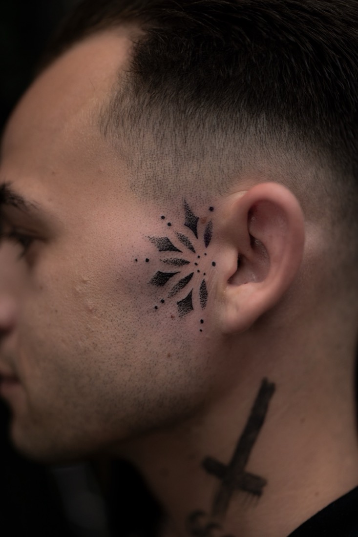 Dotwork mandala beside the ear, by Tuba at THRONE Northampton
