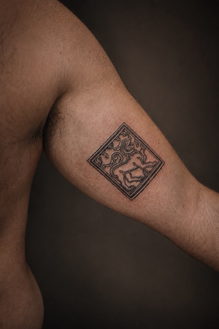Framed square panel with an ornamental lion, on an inner arm, by Tuba at THRONE Northampton